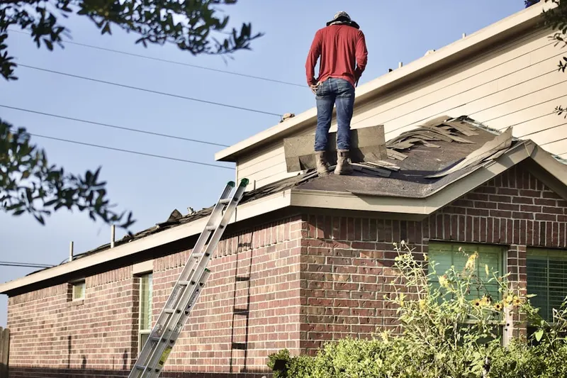 Professional roofer working on a residential roof in Cheyney